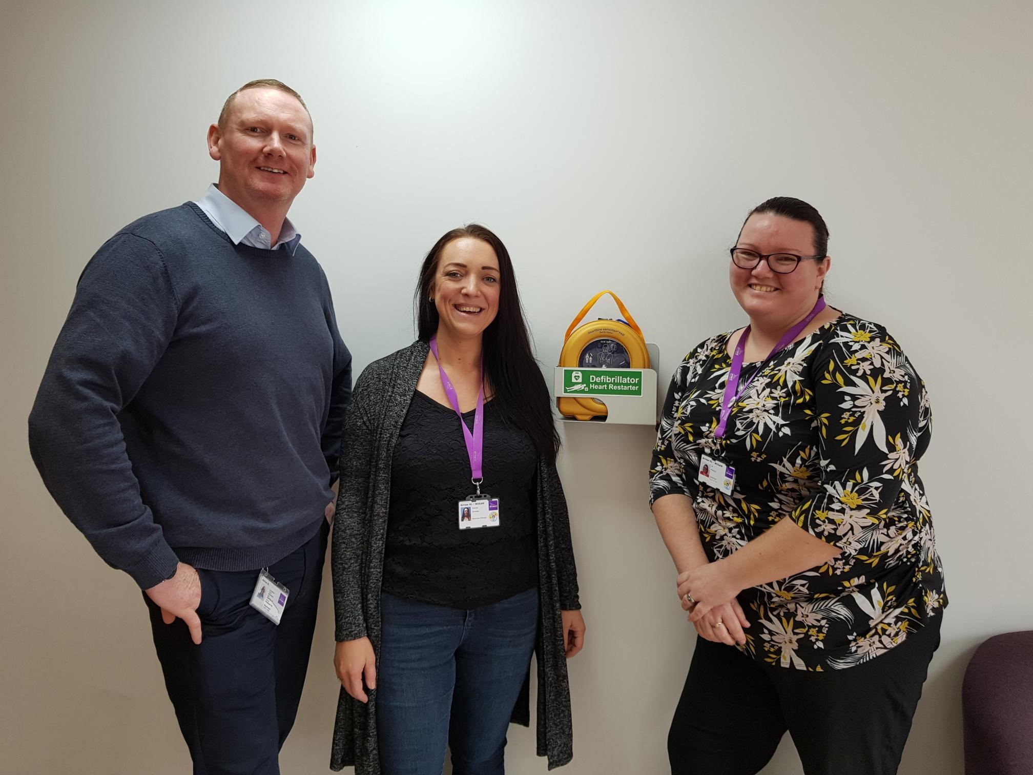 ArrowXL Head of Health and Safety shows off new defib unit with first-aid colleagues