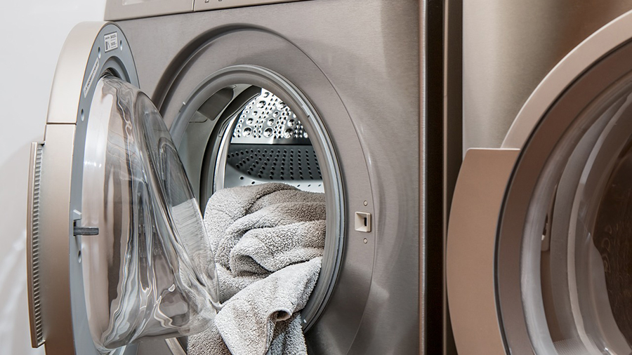 Washing machine with the door open and laundry inside