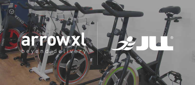 Image of exercise bikes with ArrowXL and JLL Fitness logos