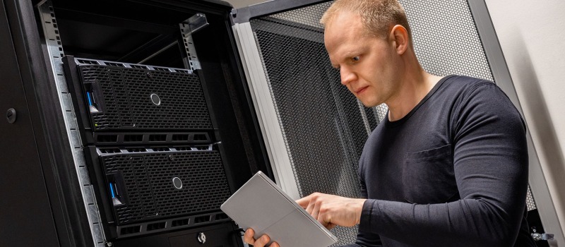 man-on-tablet-in-server-room.jpg